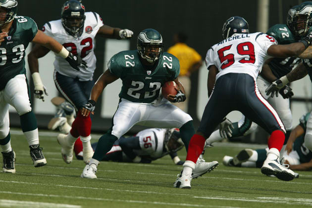 Duce Staley (22) of the Philadelphia Eagles rushes against Mitchell (59) during the game in 2002.
